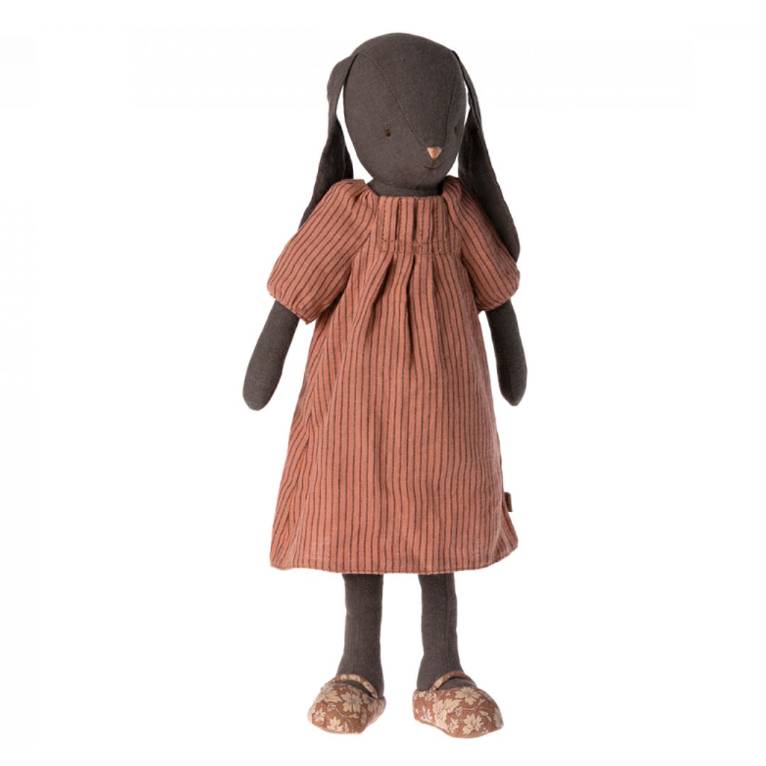 Dark brown Maileg rabbit in a reddish striped dress.