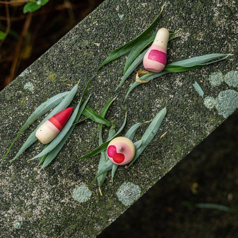 Yay! 3 Grapat Wooden Humanoid Figures with leaves on top of a stone wall